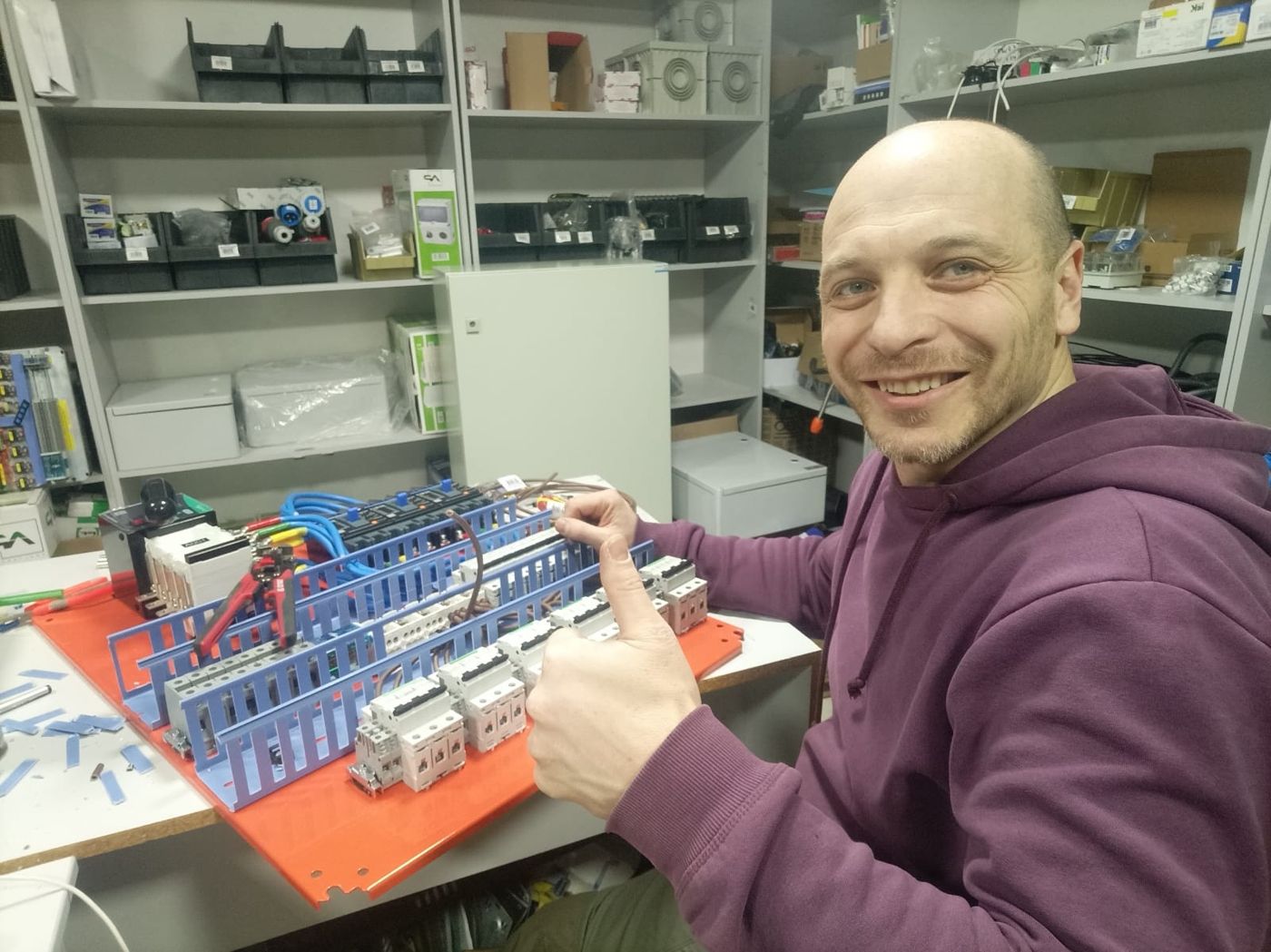Serhii Volkov assembling an electrical distribution board in his workshop